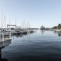 Ruhiger Yachthafen Kiel in Schleswig-Holstein mit zahlreichen Booten, klarer Wasseroberfläche und weitem Blick auf den Horizont.